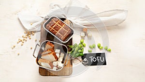 Soy food. Baked tofu cheese on a board, soybeans. Vegan product