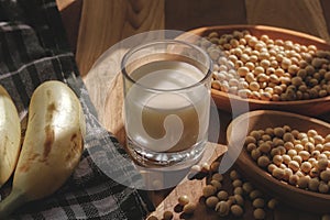 Soy milk, bananas and soy beans on a wooden table