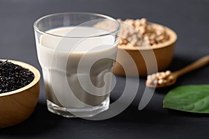 Soy milk with black sesame on black background