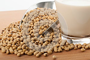 Soy milk in glass with soybeans and transfer scoop