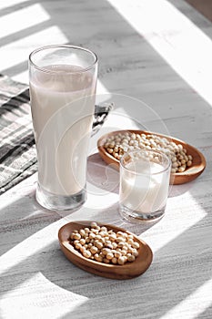 Soy milk and soy beans on a wooden table