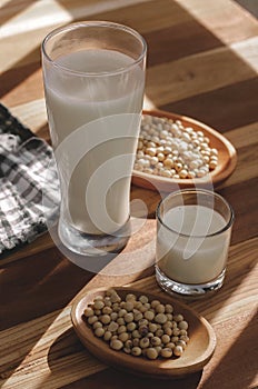 Soy milk and soy beans on a wooden table