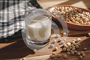 Soy milk and soy beans on a wooden table