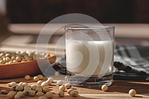 Soy milk and soy beans on a wooden table