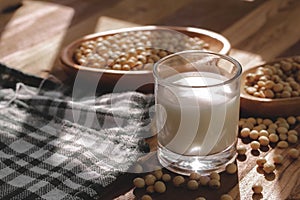 Soy milk and soy beans on a wooden table