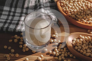 Soy milk and soy beans on a wooden table