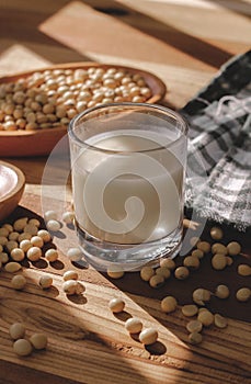 Soy milk and soy beans on a wooden table