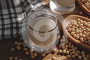 Soy milk and soy beans on a wooden table