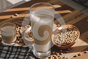Soy milk and soy beans on a wooden table