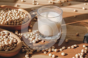 Soy milk and soy beans on a wooden table