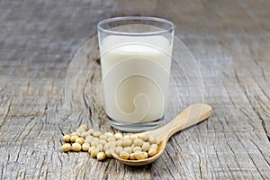 Soy milk with soybean on wooden background