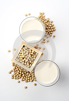 Soy milk and soybeans in a glass placed on a white background