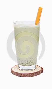 Soy products milk in tall glass on small wooden cutting board drinking straw orange.