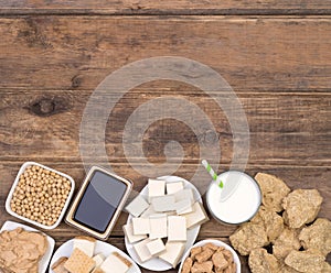Soy products on wooden background top view