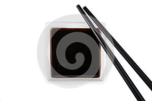 Soy sauce and chopsticks isolated on white background