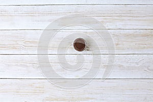 Soy sauce in small bawl for dipping, on wooden background, top view