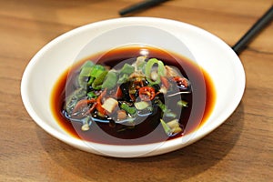 Soy sauce with spring onion. photo