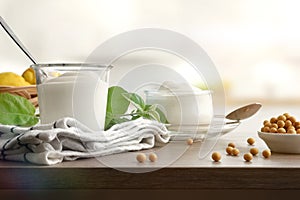 Soy yogurts on table with dry soy beans in kitchen