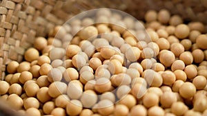 Soya beans in rustic wicker bowl. Uncooked dry soy grains. Soybean seeds.