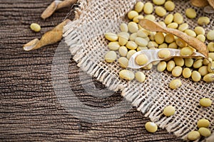 Soya beans in a sack on a old wooden table photo