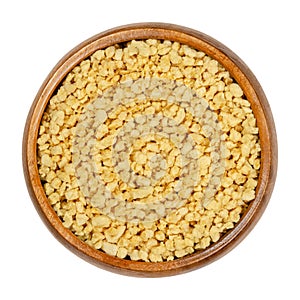 Soya granules, textured soy protein, soy meat in wooden bowl