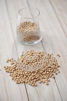 Soybean seeds in glass and wooden floor - kedelai