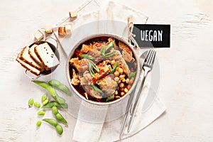 Soybean with soy meat, onion and tofu on light wooden background. Vegan food