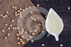 Soybean And Soy Oil On Black Wood Background