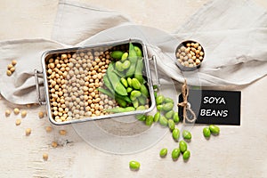 Soybeans on light cotton and wooden background. Vegan food concept