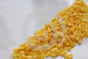 Soybeans in white plate on wood table.