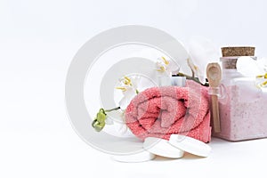 Spa accessories: soap, candle, towel, salt and orchid on white background.