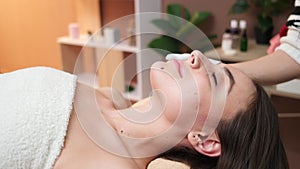 Spa. Attractive funny woman with a clay mask on her face.