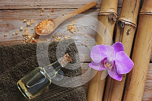 Spa background with bamboo, bath salt, massage oil, orchid flower and towel