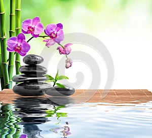 Spa background with bamboo , orchids and water