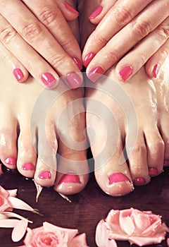 Spa background with beautiful feet, flowers and petals