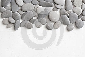 Spa background with grey stones, gray modern background, cover, template with round gray stones, flat lay. Copy space for your