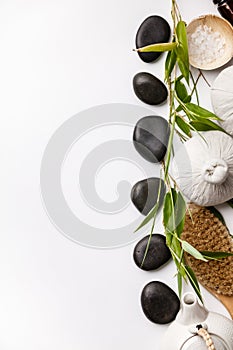 SPA background with massage compress balls, stones, sea salt, brush and teapot