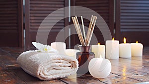 Spa background. Towel, candles, flowers, massaging stones and herbal balls. Massage, oriental therapy, wellbeing and