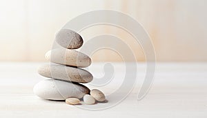 Spa, balance, meditation and zen minimal modern concept. Stack of stone pebbles against beige wall for design and presentation