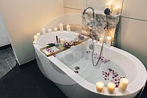 Spa bath with flowers, candles and tray