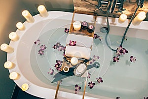 Spa bath with flowers, candles and tray