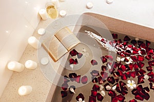 Spa bath with petals and candles