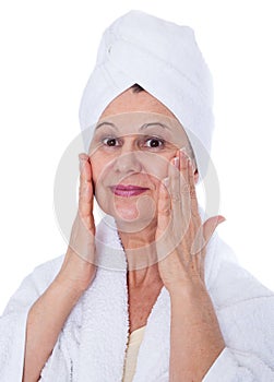 Spa and beauty concept. Aged good looking woman with white towel on her head. UK