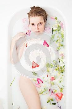 Spa beauty girl bathing in milk bath, spa and skin care concept. Beauty young Woman with perfect slim body and soft skin, in