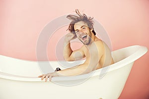 Spa and beauty, man with muscular body sitting in bathtub