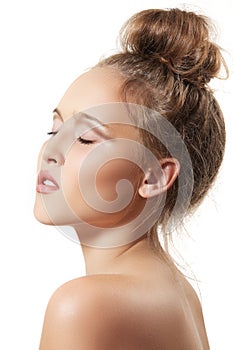 Spa beauty model with clean skin and bun hairstyle