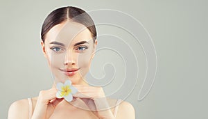 Spa beauty portrait of young woman with healthy clear skin and flower
