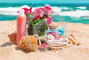 Spa beauty products: towels, soap, shells, sea salt and pink flo