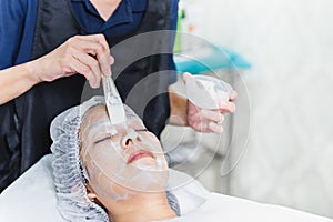 Spa beauty treatment skin care woman getting facial care by beautician at spa salon.