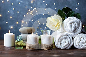 Spa, beauty treatment and wellness background Towel Cosmetic Massage oil, flowers, lights and candel